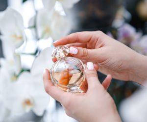 Women's hands hold a bottle of perfume. Elegance and luxury. Eau de Toilette. Cosmetics/ envato / katrinasid