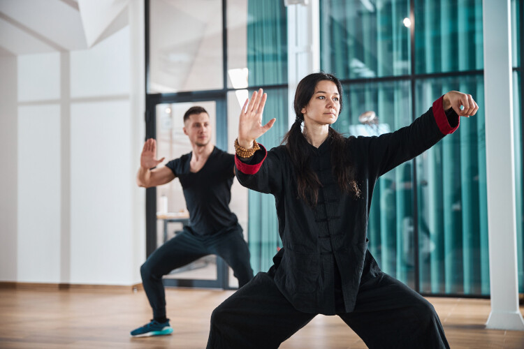 woman-giving-a-tai-chi-lesson-indoors-2021-09-03-07-02-59-utc